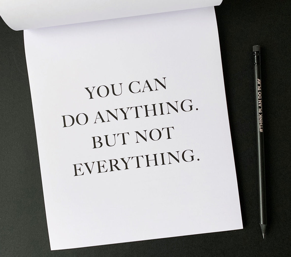 Minimal monochrome notepad page with the quote “You can do anything. But not everything.” — a calm reminder to focus on what matters.