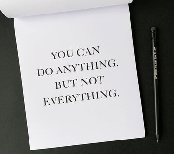 Minimal monochrome notepad page with the quote “You can do anything. But not everything.” — a calm reminder to focus on what matters.