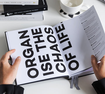 Open HELLO TIME planner with bold black text reading “Organise the chaos of life” — the ultimate tool for calm, confident planning.