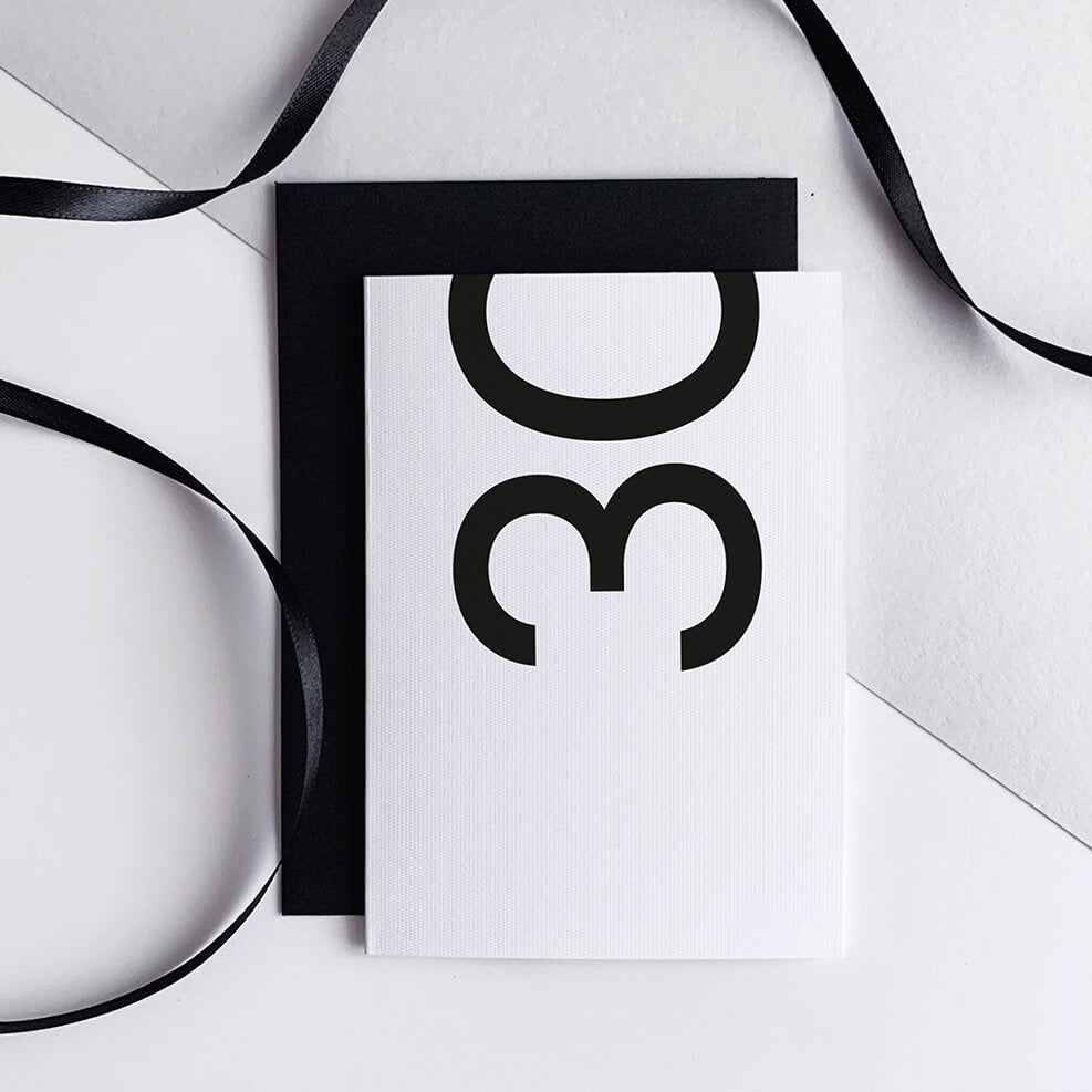 White 30th birthday card with bold black number and black envelope.