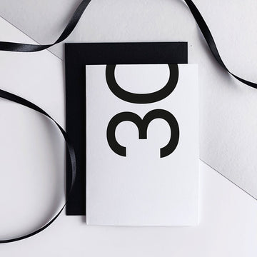 White 30th birthday card with bold black number and black envelope.