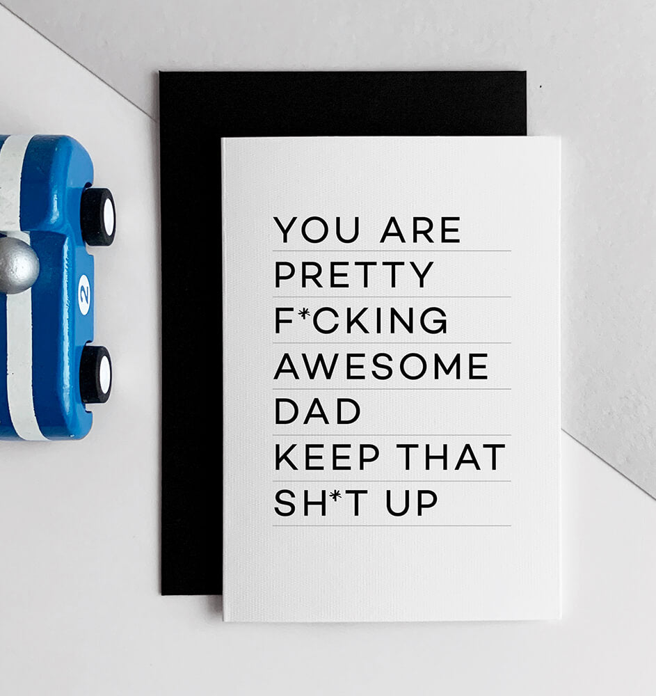 White greetings card with bold black text reading “You are pretty fcking awesome dad keep that sht up,” with black envelope.