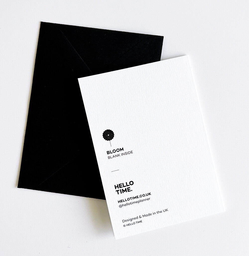 White card with bold black floral bunch design, paired with black envelope and pencil.