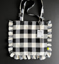 Black and white gingham ruffle tote bag with handles and product tag