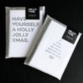 Pack of Christmas quote cards wrapped in Hello Time packaging with text “Have Yourself a Holly Jolly Xmas” and tree design visible.