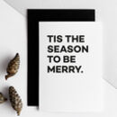 White greeting card with bold black text reading “Tis the Season to Be Merry.”