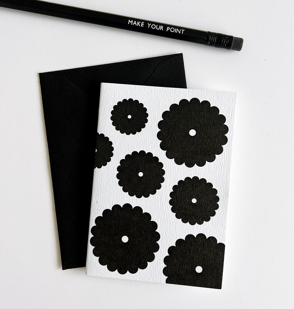 White card with bold black floral bunch design, paired with black envelope and pencil.