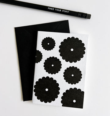 White card with bold black floral bunch design, paired with black envelope and pencil.
