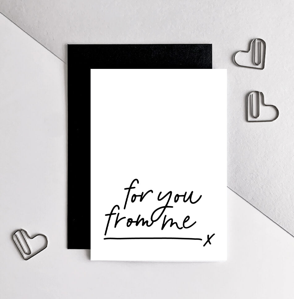 Hand holding monochrome birthday card with handwritten text “for you from me,” packaged with black envelope.