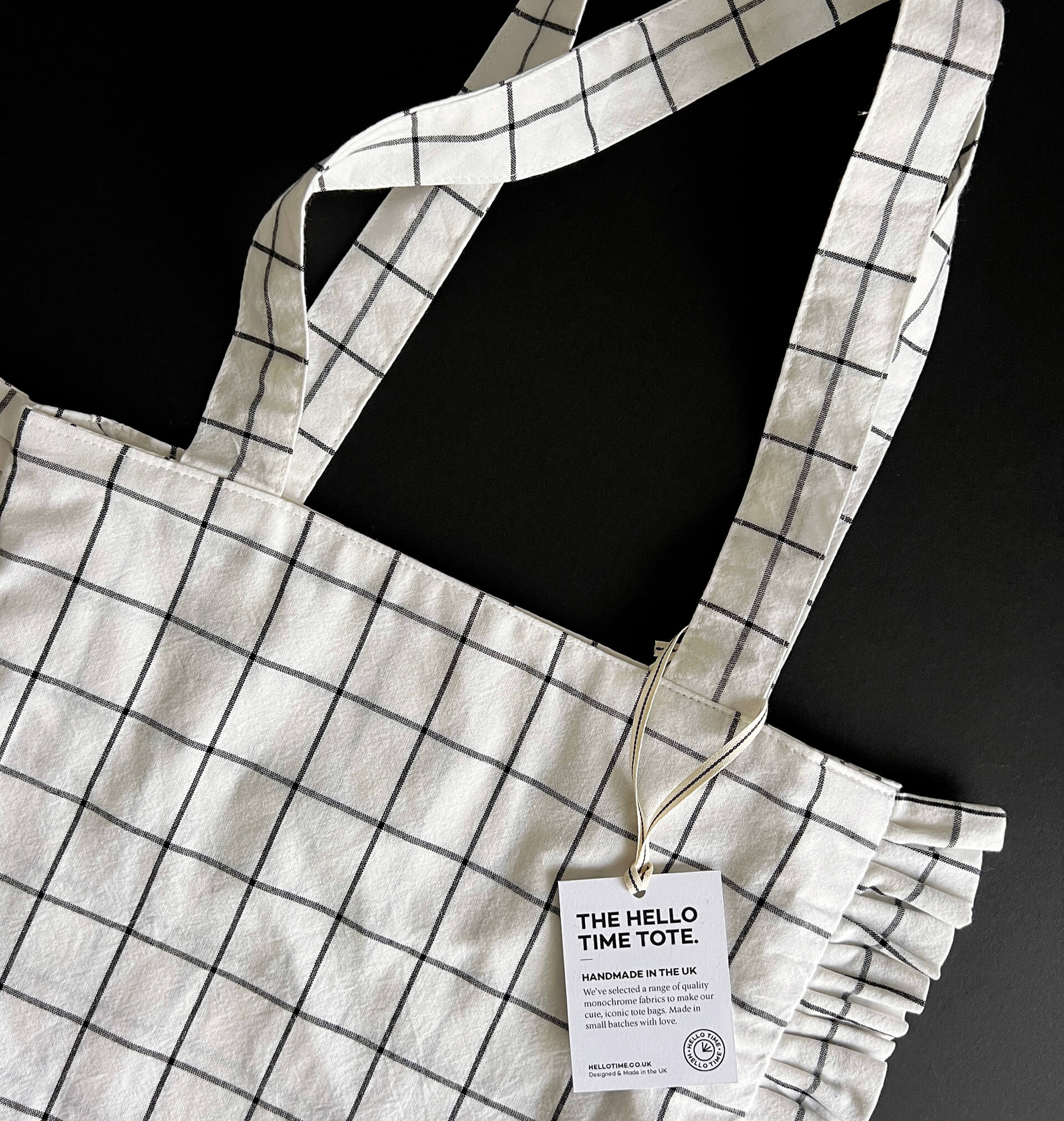 Close-up of top section and handles of Hello Time grid tote bag
