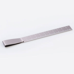 Silver metal ruler bookmark with clip, marked with centimetre scale.