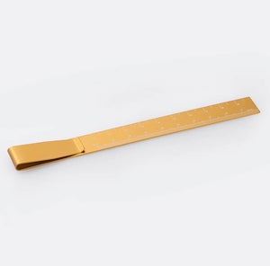 Yellow metal ruler bookmark with clip, marked with centimetre scale.