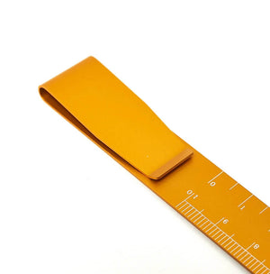 Yellow clip ruler bookmark with centimetre markings on white background
