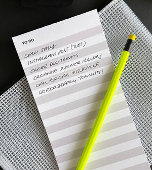 HELLO TIME braindump to-do list pad with handwritten notes and neon yellow pencil on mesh pouch
