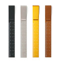 Four clip ruler bookmarks in black, grey, yellow and bronze on white background