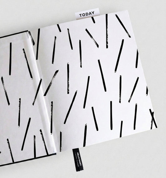 Open HELLO TIME planner with black scattered line-pattern endpaper and "Today" bookmark tab visible.
