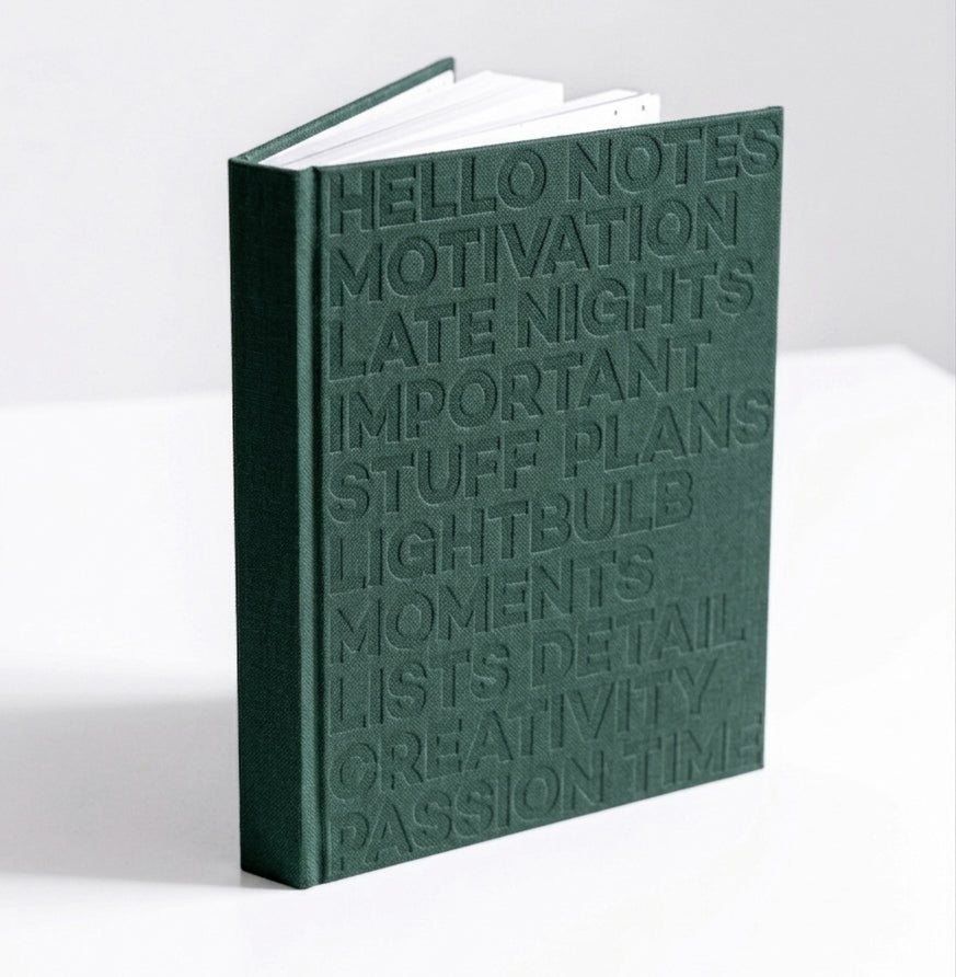 Green HELLO TIME planner standing upright, showing embossed cover text on white background.