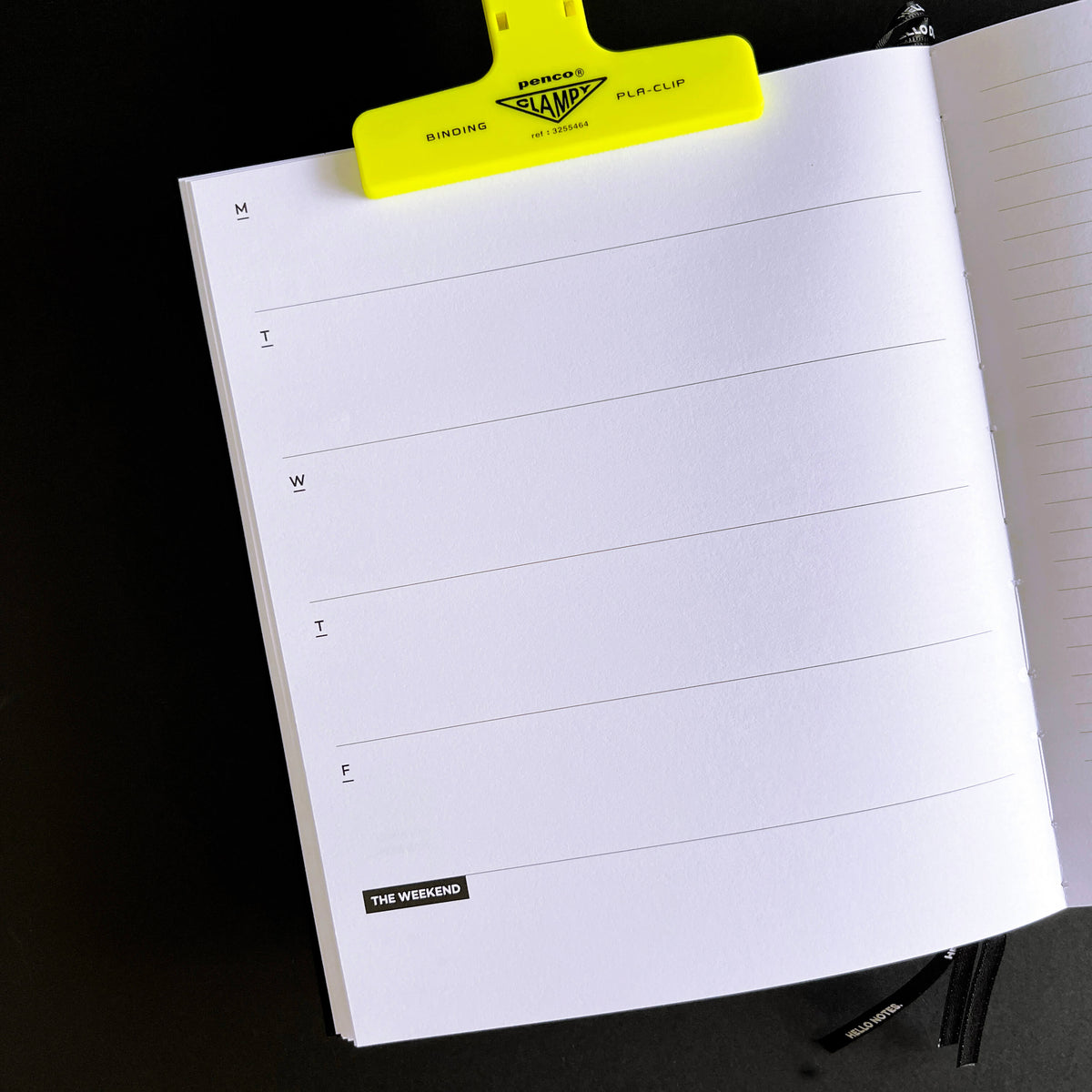 Open HELLO TIME weekly planner page with day-by-day lines and "The Weekend" label, yellow clip attached.