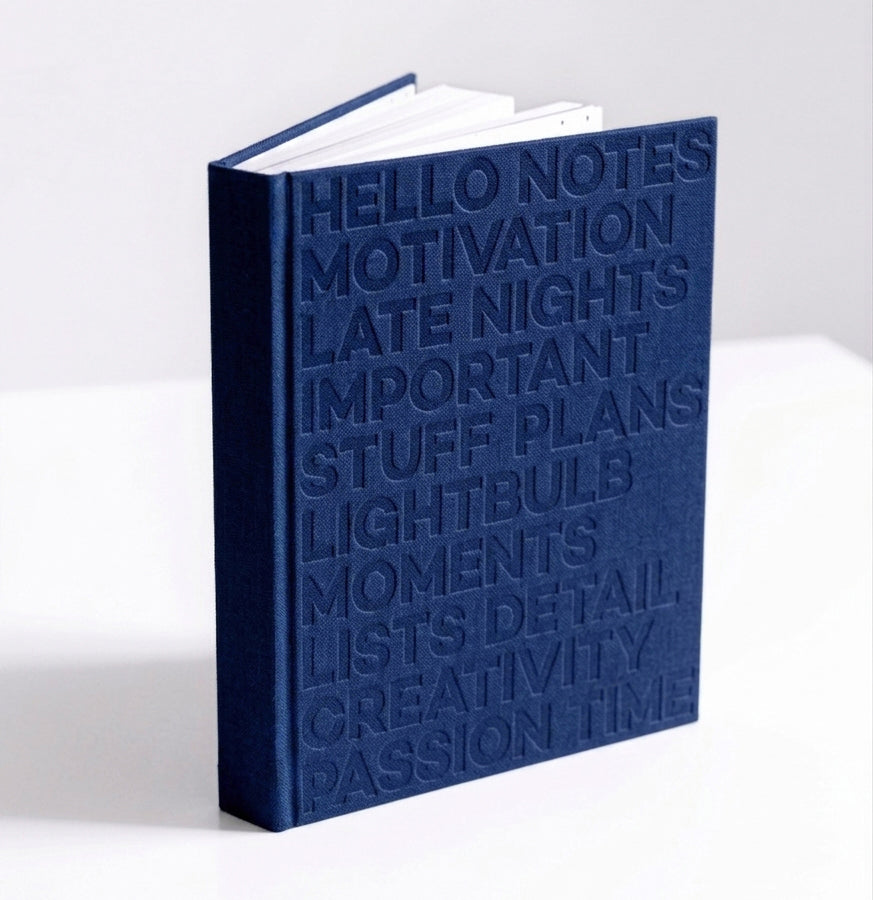 Navy blue HELLO TIME planner standing upright, showing embossed cover text on white background.