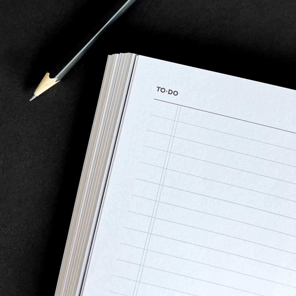 Open HELLO TIME planner "To-Do" list page with ruled lines and pencil beside it on black background.