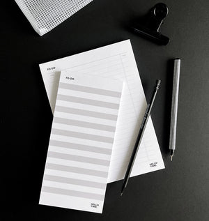 HELLO TIME striped braindump to-do pad and Time-Task-Tick pad with black pencil and black fineliner on dark background