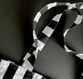 Detail of monochrome striped fabric handles on the HELLO TIME tote bag