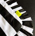 Close-up of black and white striped HELLO TIME tote bag with neon yellow tab and pleated edge.