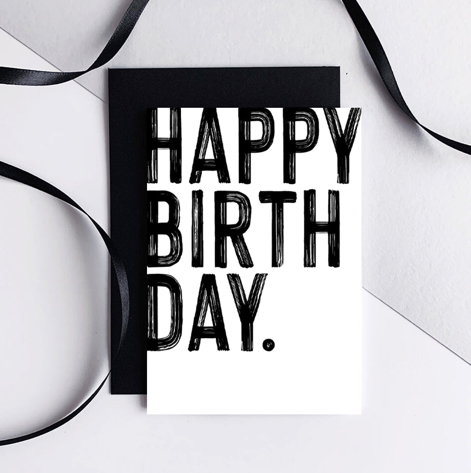 Bold monochrome Happy Birthday greetings card shown in display rack