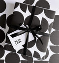 Black and white geometric gift wrap design with black sparkle ribbon and 'with love' gift card.