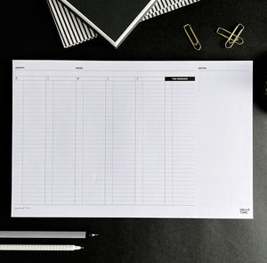 Hello Time My Week Planning Desk Pad flat lay with pens and stationery, full weekly layout shown