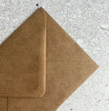 Brown kraft envelope shown on grey background, designed to pair with One of a Kind birthday card.
