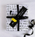 HELLO TIME Life Planning Kit wrapped in monochrome paper with black ribbon, pencil, fineliner and yellow leather page marker attached
