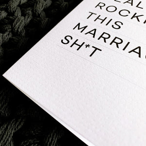 Close-up of white textured card with bold black text 