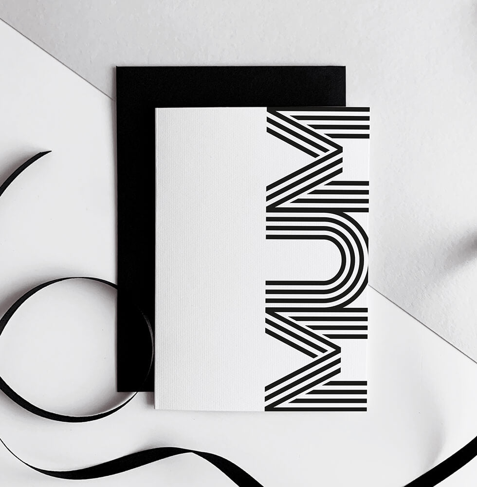 White greetings card with bold black MUM typography, paired with black envelope.