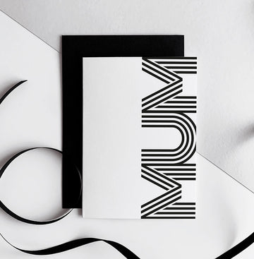 White greetings card with bold black MUM typography, paired with black envelope.