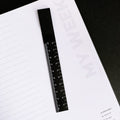 Black ruler bookmark on weekly planner page titled “My Week”