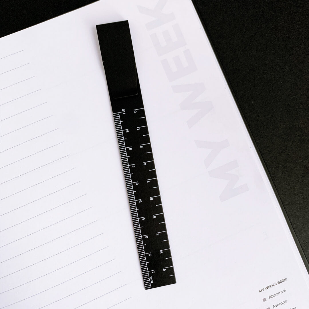 Black ruler bookmark on weekly planner page titled “My Week”