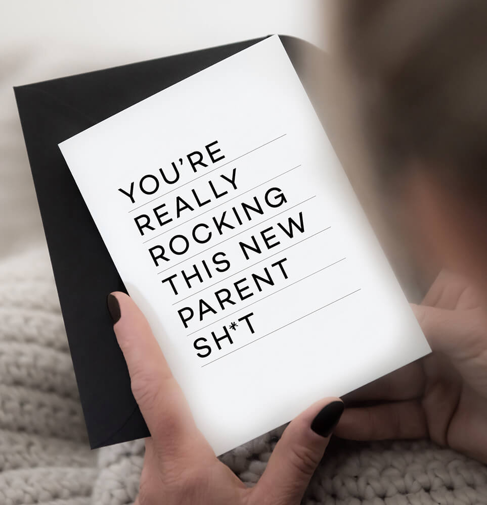 Black and white New Parents greetings card with bold typography on white card, paired with a black envelope.