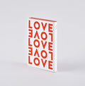 Nuuna LOVE notebook with bold red typography on a white cover