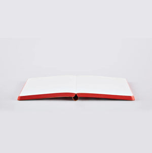 Nuuna LOVE notebook lying open flat with red-edged white pages