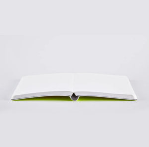 Nuuna Neon Yellow notebook lying open flat to show binding and clean dotted pages