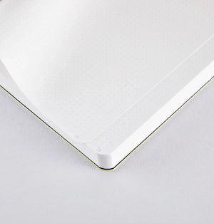 Interior close-up of Nuuna Neon Yellow notebook showing mini dot grid layout on white premium paper