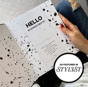 HELLO TIME personalised planner open with custom message “Hello Business Bestie” with black inkwell design and person holding notebook. Featured in Stylist Magazine.