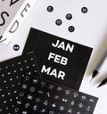 Black sticker sheets showing months, numbers, and white icon activity markers