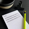 HELLO TIME Top 3 To-Do List Pad with handwritten tasks, yellow pencil, black clip and ceramic bowl on desk