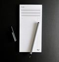 HELLO TIME Top 3 To-Do List Pad with black and white striped pen on black background