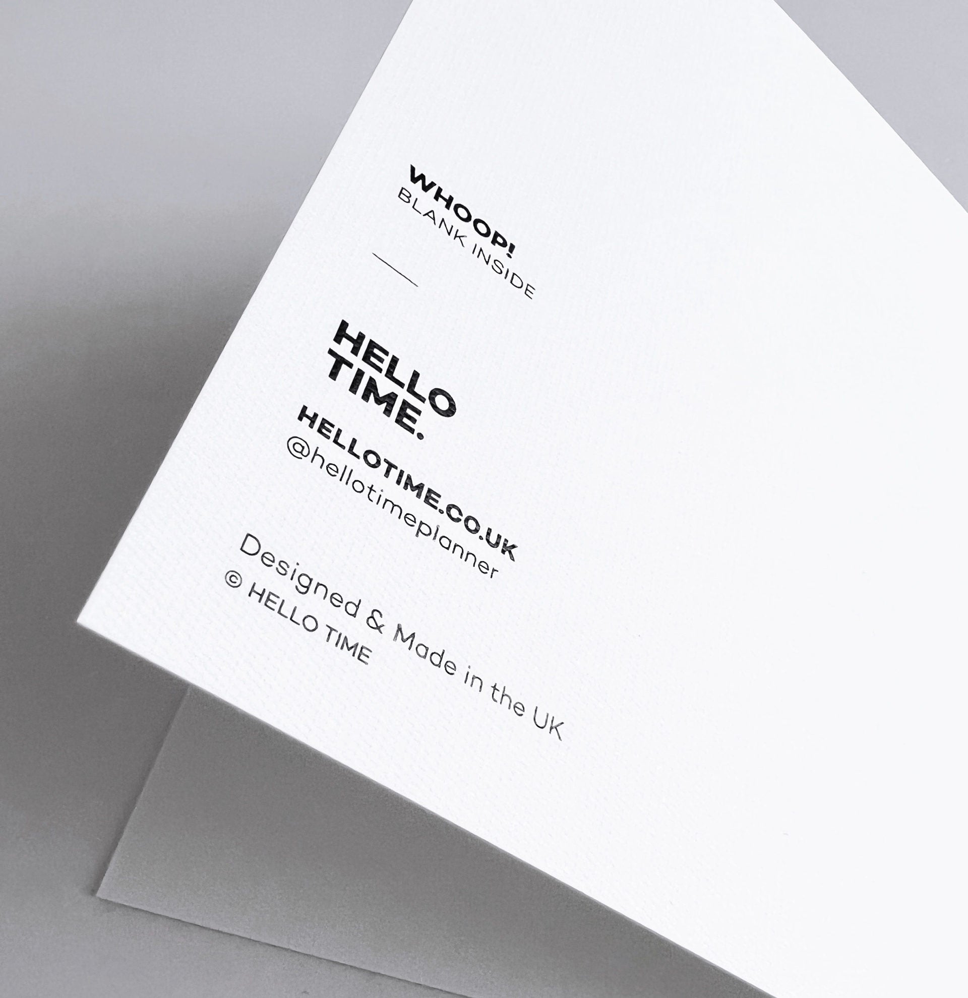 Back of monochrome greetings card showing Hello Time logo and FSC details.