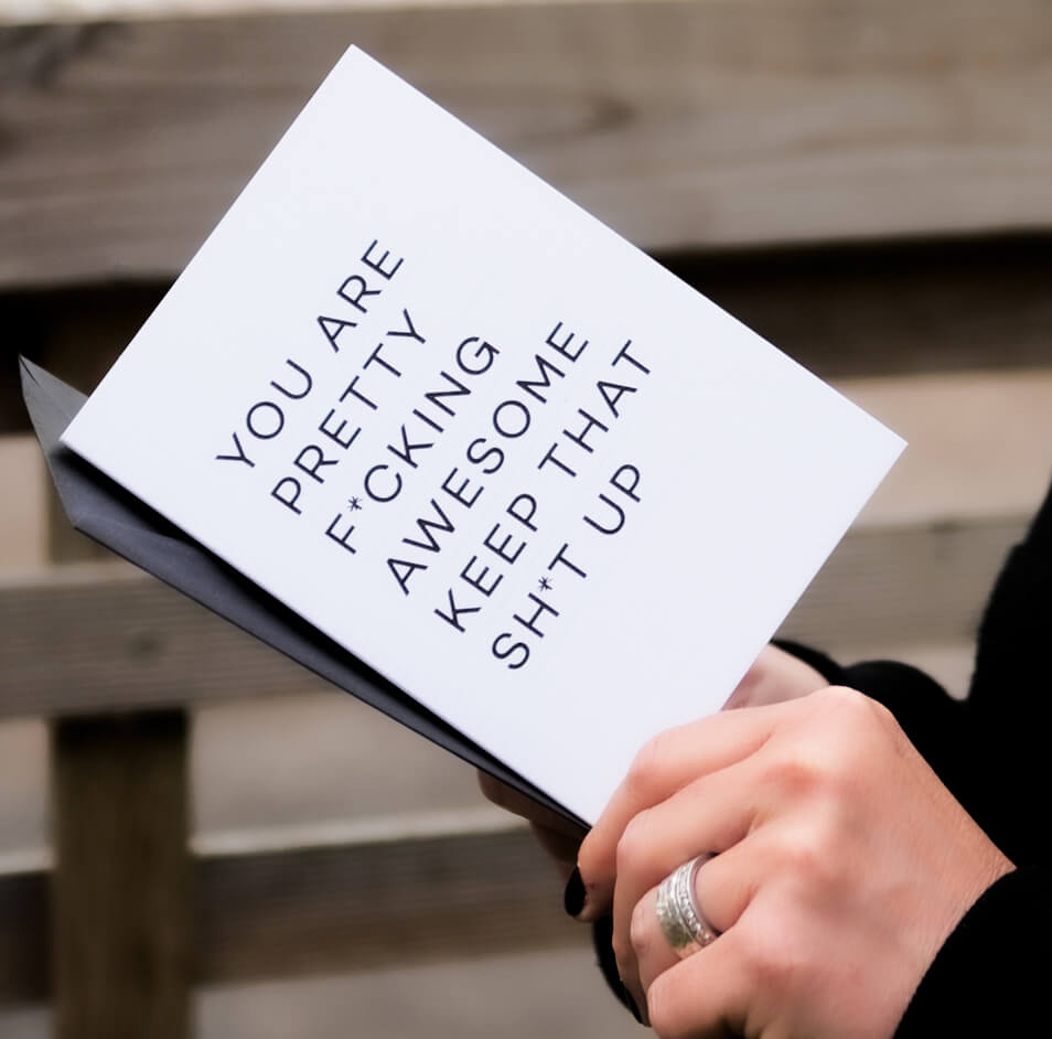 Birthday card shown with matching black envelope, white card features bold typographic design.