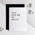 White greetings card with bold black text 'You Had Me At Hello' and black envelope.