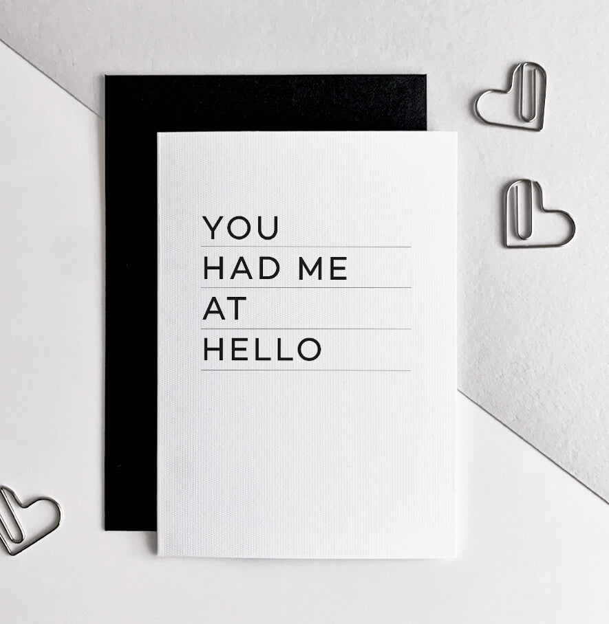 White greetings card with bold black text 'You Had Me At Hello' and black envelope.